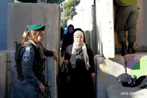 Palestinians are checked at an Israeli checkpoint between the West Bank town of Bethlehem and Jerusalem as Muslim worshippers head to Jerusalem's Al-Aqsa mosque for the second Friday prayer of the holy Muslim fasting mon...