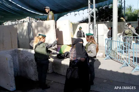 Palestinians are checked at an Israeli checkpoint between the West Bank town of Bethlehem and Jerusalem as Muslim worshippers head to Jerusalem's Al-Aqsa mosque for the second Friday prayer of the holy Muslim fasting mon...