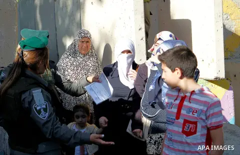 Palestinians are checked at an Israeli checkpoint between the West Bank town of Bethlehem and Jerusalem as Muslim worshippers head to Jerusalem's Al-Aqsa mosque for the second Friday prayer of the holy Muslim fasting mon...