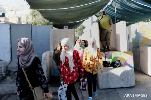 Palestinians are checked at an Israeli checkpoint between the West Bank town of Bethlehem and Jerusalem as Muslim worshippers head to Jerusalem's Al-Aqsa mosque for the second Friday prayer of the holy Muslim fasting mon...