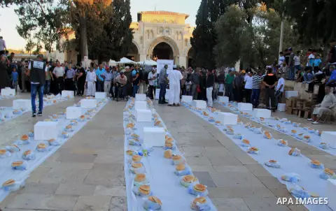 Palestinian muslims prepare to break their fast during the holy fasting month of Ramadan in front of the Dome of the Rock mosque at the al-Aqsa mosque compound in Jerusalem's old city on June 17, 2016 during the holy fas...