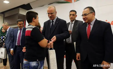 Palestinian Prime Minister, Rami Hamdallah, Participate in the central collective breakfast for the families of martyrs during the fasting month of Ramadan, in the West bank city of Ramallah, on June 17, 2016. Ramadan is...