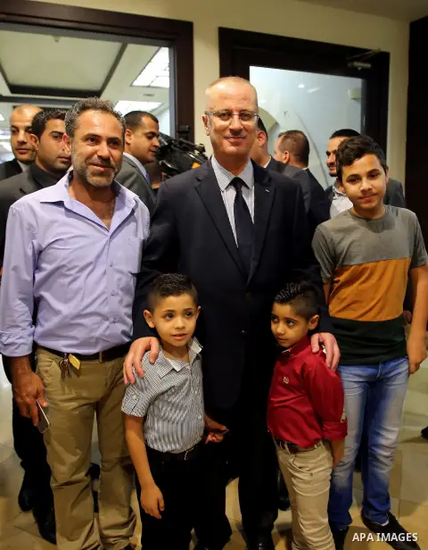 Palestinian Prime Minister, Rami Hamdallah, Participate in the central collective breakfast for the families of martyrs during the fasting month of Ramadan, in the West bank city of Ramallah, on June 17, 2016. Ramadan is...