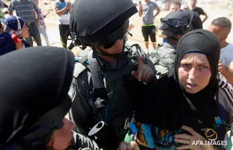 Palestinians scuffle with an Israeli border policeman as Israeli troops demolish sheds belonging to Palestinians near the West Bank village of Yatta, south of Hebron June 19, 2016. Photo by Wisam Hashlamoun