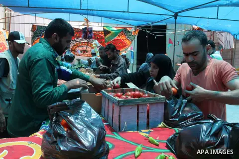Palestinians shop at the Ramadan Charity market for poor families, Funded by "Gift of the Givers" South Africa, in Khan Younis in the southern Gaza strip, on June 20, 2016. Photo by Abed Rahim Khatib