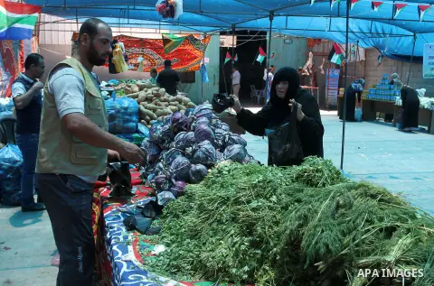 Palestinians shop at the Ramadan Charity market for poor families, Funded by "Gift of the Givers" South Africa, in Khan Younis in the southern Gaza strip, on June 20, 2016. Photo by Abed Rahim Khatib