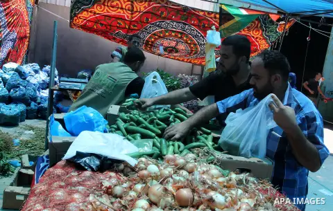 Palestinians shop at the Ramadan Charity market for poor families, Funded by "Gift of the Givers" South Africa, in Khan Younis in the southern Gaza strip, on June 20, 2016. Photo by Abed Rahim Khatib