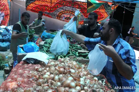 Palestinians shop at the Ramadan Charity market for poor families, Funded by "Gift of the Givers" South Africa, in Khan Younis in the southern Gaza strip, on June 20, 2016. Photo by Abed Rahim Khatib