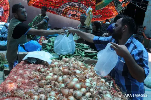 Palestinians shop at the Ramadan Charity market for poor families, Funded by "Gift of the Givers" South Africa, in Khan Younis in the southern Gaza strip, on June 20, 2016. Photo by Abed Rahim Khatib