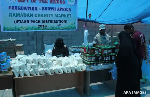 Palestinians shop at the Ramadan Charity market for poor families, Funded by "Gift of the Givers" South Africa, in Khan Younis in the southern Gaza strip, on June 20, 2016. Photo by Abed Rahim Khatib