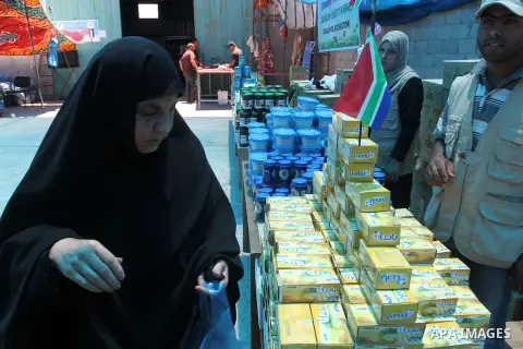 Palestinians shop at the Ramadan Charity market for poor families, Funded by "Gift of the Givers" South Africa, in Khan Younis in the southern Gaza strip, on June 20, 2016. Photo by Abed Rahim Khatib