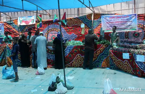 Palestinians shop at the Ramadan Charity market for poor families, Funded by "Gift of the Givers" South Africa, in Khan Younis in the southern Gaza strip, on June 20, 2016. Photo by Abed Rahim Khatib