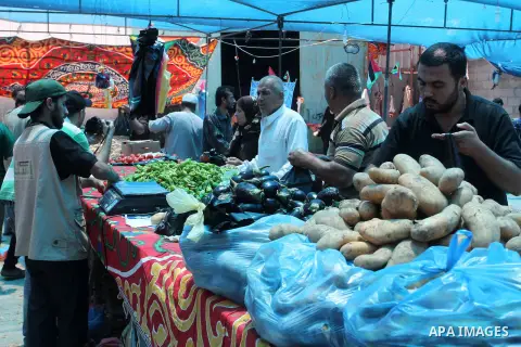 Palestinians shop at the Ramadan Charity market for poor families, Funded by "Gift of the Givers" South Africa, in Khan Younis in the southern Gaza strip, on June 20, 2016. Photo by Abed Rahim Khatib