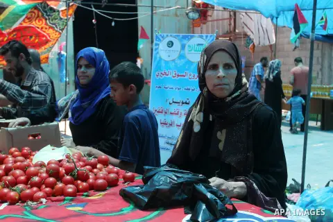 Palestinians shop at the Ramadan Charity market for poor families, Funded by "Gift of the Givers" South Africa, in Khan Younis in the southern Gaza strip, on June 20, 2016. Photo by Abed Rahim Khatib