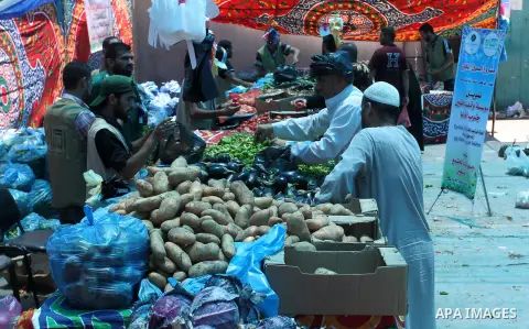Palestinians shop at the Ramadan Charity market for poor families, Funded by "Gift of the Givers" South Africa, in Khan Younis in the southern Gaza strip, on June 20, 2016. Photo by Abed Rahim Khatib