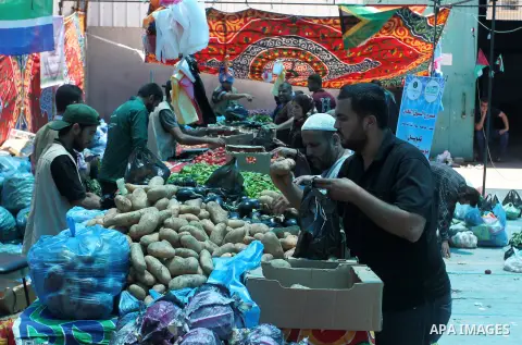 Palestinians shop at the Ramadan Charity market for poor families, Funded by "Gift of the Givers" South Africa, in Khan Younis in the southern Gaza strip, on June 20, 2016. Photo by Abed Rahim Khatib