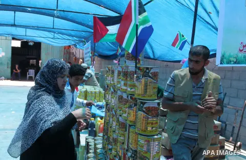 Palestinians shop at the Ramadan Charity market for poor families, Funded by "Gift of the Givers" South Africa, in Khan Younis in the southern Gaza strip, on June 20, 2016. Photo by Abed Rahim Khatib