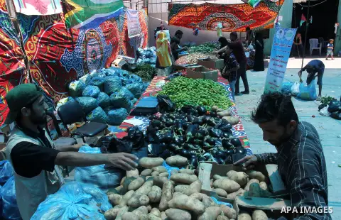 Palestinians shop at the Ramadan Charity market for poor families, Funded by "Gift of the Givers" South Africa, in Khan Younis in the southern Gaza strip, on June 20, 2016. Photo by Abed Rahim Khatib