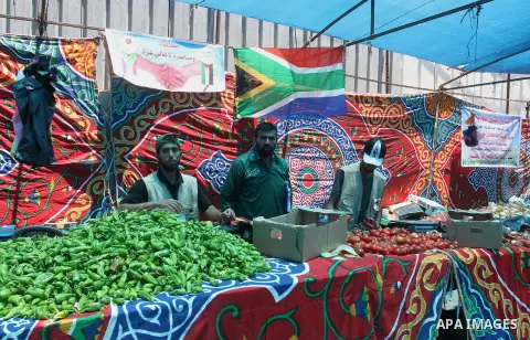 Palestinians shop at the Ramadan Charity market for poor families, Funded by "Gift of the Givers" South Africa, in Khan Younis in the southern Gaza strip, on June 20, 2016. Photo by Abed Rahim Khatib