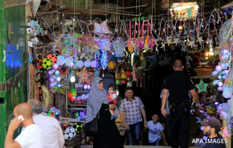 Palestinians shop at a market during the holy fasting month of Ramadan, in Jerusalem's old city on June 20, 2016. Ramadan is sacred to Muslims because it is during that month that tradition says the Koran was revealed to...