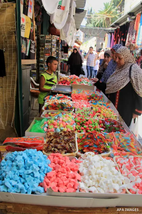 Palestinians shop at a market during the holy fasting month of Ramadan, in Jerusalem's old city on June 20, 2016. Ramadan is sacred to Muslims because it is during that month that tradition says the Koran was revealed to...