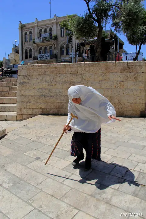 A Palestinian woman walks following (Asr) prayer during the holy fasting month of Ramadan at al-Aqsa mosque, in Jerusalem's old city on June 20, 2016. Ramadan is sacred to Muslims because it is during that month that tra...