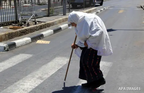 A Palestinian woman walks following (Asr) prayer during the holy fasting month of Ramadan at al-Aqsa mosque, in Jerusalem's old city on June 20, 2016. Ramadan is sacred to Muslims because it is during that month that tra...
