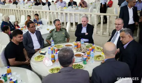 Palestinian Prime Minister Rami Hamdallah takes part during take breakfast on holy fasting month of Ramadan, in the West Bank city of Tulkarem, on June 20, 2016. Photo by Prime Minister Office