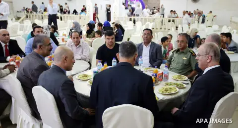 Palestinian Prime Minister Rami Hamdallah takes part during take breakfast on holy fasting month of Ramadan, in the West Bank city of Tulkarem, on June 20, 2016. Photo by Prime Minister Office