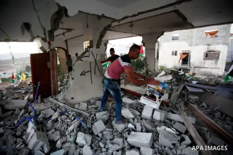 A Palestinian boy inspects the home of the Bashar Masalha that was demolished by the Israeli military in the West bank city of Qalqilya, on June 21, 2016. Bashar Masalha was killed in Jaffa city on 8 March 2016, under th...