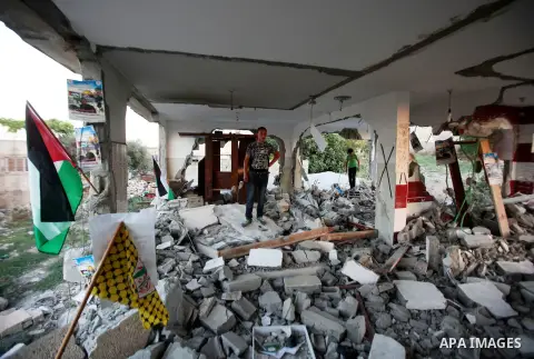A Palestinian boy inspects the home of the Bashar Masalha that was demolished by the Israeli military in the West bank city of Qalqilya, on June 21, 2016. Bashar Masalha was killed in Jaffa city on 8 March 2016, under th...