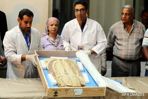Egyptian antiquities officials carry a lid of a sarcophagus on its arrival to the Egyptian Museum in Cairo, Egypt, on June 21, 2016. Two ancient Egyptian sarcophagus covers have been delivered to Cairo's Egyptian Museum...