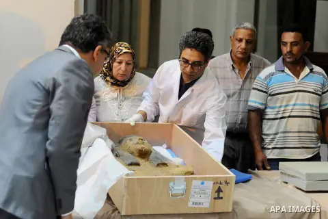 Egyptian antiquities officials inspect a sarcophagus cover on its arrival to the Egyptian Museum in Cairo, Egypt, on June 21, 2016. Two ancient Egyptian sarcophagus covers have been delivered to Cairo's Egyptian Museum a...