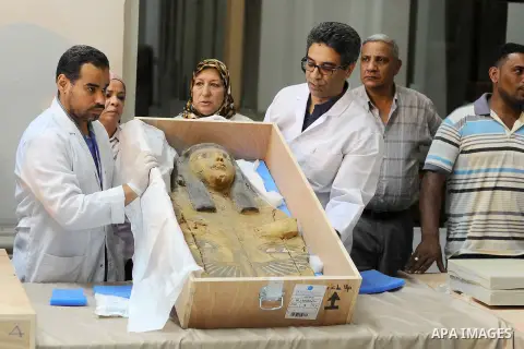 Egyptian antiquities officials inspect a sarcophagus cover on its arrival to the Egyptian Museum in Cairo, Egypt, on June 21, 2016. Two ancient Egyptian sarcophagus covers have been delivered to Cairo's Egyptian Museum a...