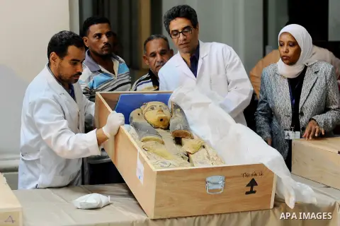 Egyptian antiquities officials inspect a sarcophagus cover on its arrival to the Egyptian Museum in Cairo, Egypt, on June 21, 2016. Two ancient Egyptian sarcophagus covers have been delivered to Cairo's Egyptian Museum a...