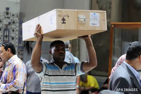 Egyptian antiquities officials carry a lid of a sarcophagus on its arrival to the Egyptian Museum in Cairo, Egypt, on June 21, 2016. Two ancient Egyptian sarcophagus covers have been delivered to Cairo's Egyptian Museum...