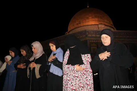 Palestinian Muslim worshippers perform "Taraweeh", nightly prayer of the month of Ramadan, in front of the Dome of the Rock mosque, in Jerusalem's old city on June 21, 2016. Ramadan is sacred to Muslims because it is dur...