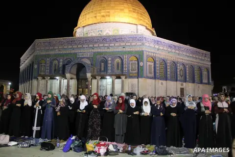 Palestinian Muslim worshippers perform "Taraweeh", nightly prayer of the month of Ramadan, in front of the Dome of the Rock mosque, in Jerusalem's old city on June 21, 2016. Ramadan is sacred to Muslims because it is dur...