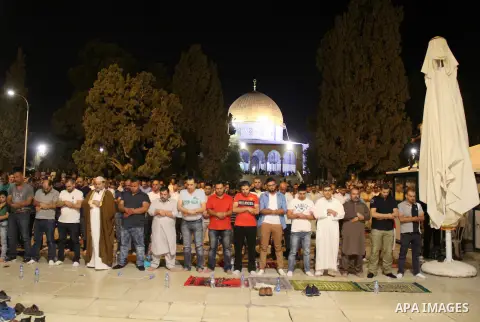 Palestinian Muslim worshippers perform "Taraweeh", nightly prayer of the month of Ramadan, in front of the Dome of the Rock mosque, in Jerusalem's old city on June 21, 2016. Ramadan is sacred to Muslims because it is dur...