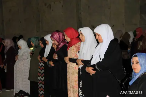 Palestinian Muslim worshippers perform "Taraweeh", nightly prayer of the month of Ramadan, in front of the Dome of the Rock mosque, in Jerusalem's old city on June 21, 2016. Ramadan is sacred to Muslims because it is dur...