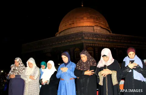 Palestinian Muslim worshippers perform "Taraweeh", nightly prayer of the month of Ramadan, in front of the Dome of the Rock mosque, in Jerusalem's old city on June 21, 2016. Ramadan is sacred to Muslims because it is dur...