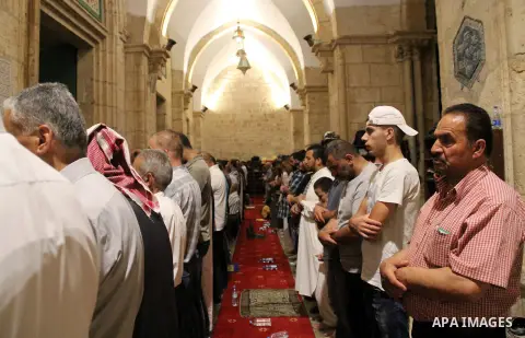 Palestinian Muslim worshippers perform "Taraweeh", nightly prayer of the month of Ramadan, in front of the Dome of the Rock mosque, in Jerusalem's old city on June 21, 2016. Ramadan is sacred to Muslims because it is dur...