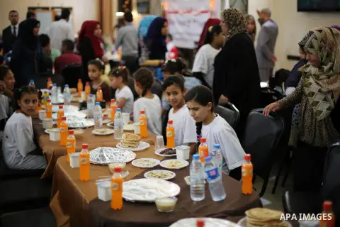 Palestinian orphan children break their fast during the holy fasting month of Ramadan in Gaza city on June 22, 2016. Ramadan is sacred to Muslims because it is during that month that tradition says the Koran was revealed...