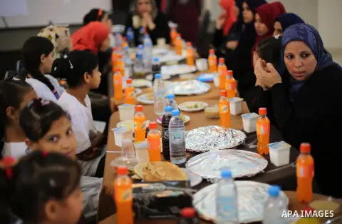 Palestinian orphan children break their fast during the holy fasting month of Ramadan in Gaza city on June 22, 2016. Ramadan is sacred to Muslims because it is during that month that tradition says the Koran was revealed...