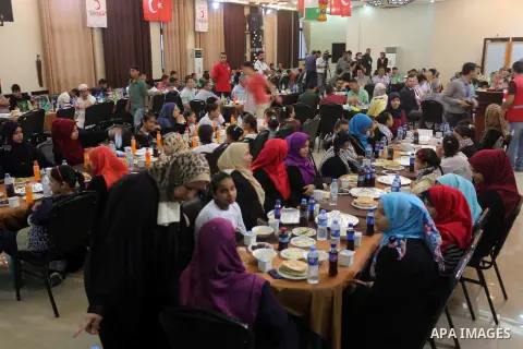 Palestinian orphan children break their fast during the holy fasting month of Ramadan in Gaza city on June 22, 2016. Ramadan is sacred to Muslims because it is during that month that tradition says the Koran was revealed...