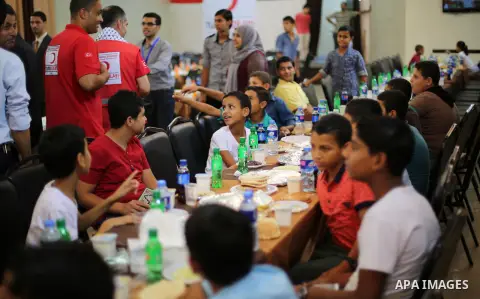 Palestinian orphan children break their fast during the holy fasting month of Ramadan in Gaza city on June 22, 2016. Ramadan is sacred to Muslims because it is during that month that tradition says the Koran was revealed...
