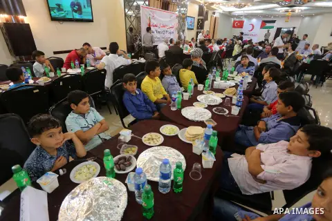 Palestinian orphan children break their fast during the holy fasting month of Ramadan in Gaza city on June 22, 2016. Ramadan is sacred to Muslims because it is during that month that tradition says the Koran was revealed...