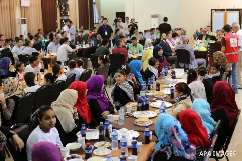 Palestinian orphan children break their fast during the holy fasting month of Ramadan in Gaza city on June 22, 2016. Ramadan is sacred to Muslims because it is during that month that tradition says the Koran was revealed...