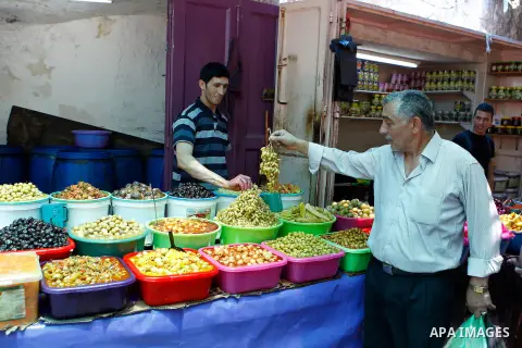 A Palestinian man sells pickles on the holy month of Ramadan at market in the Old City of the West Bank town of Hebron on June 22, 2016. Ramadan is sacred to Muslims because it is during that month that tradition says th...