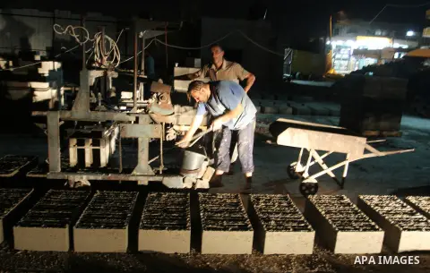Palestinian labourers work at a cement factory at night to avoid the day time heat in Rafah in the southern Gaza Strip on June 22, 2016 during Islam's holy fasting month of Ramadan. Ramadan is sacred to Muslims because i...